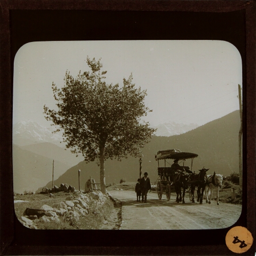Horse-drawn carriage and people walking on mountain road