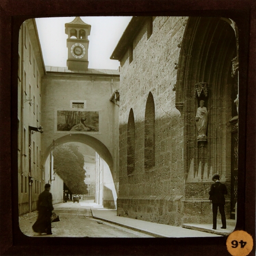 Archway and church entrance in street in unidentified town