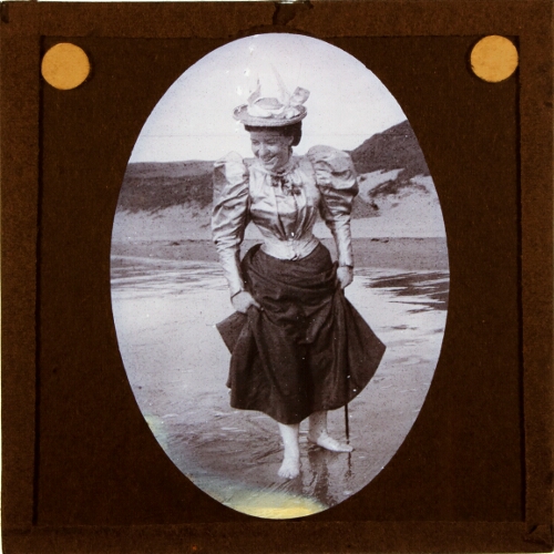 Woman paddling on beach
