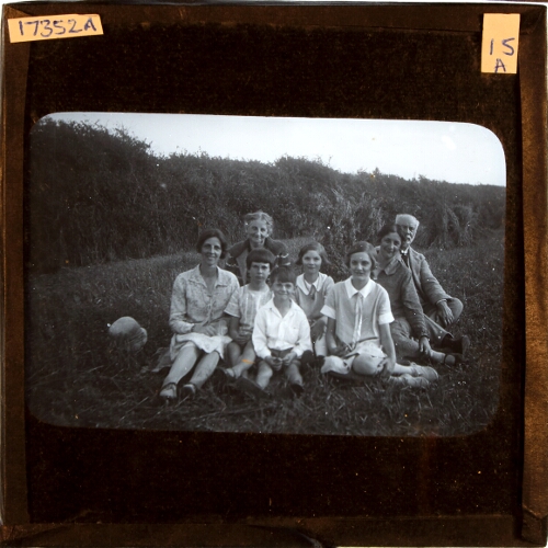 Family group sitting in field