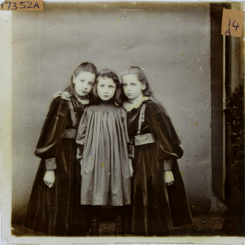 Three girls standing close together