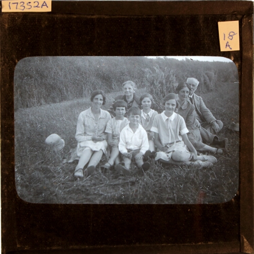 Family group sitting in field