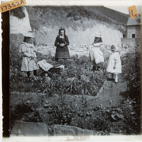 Woman and three girls standing in garden