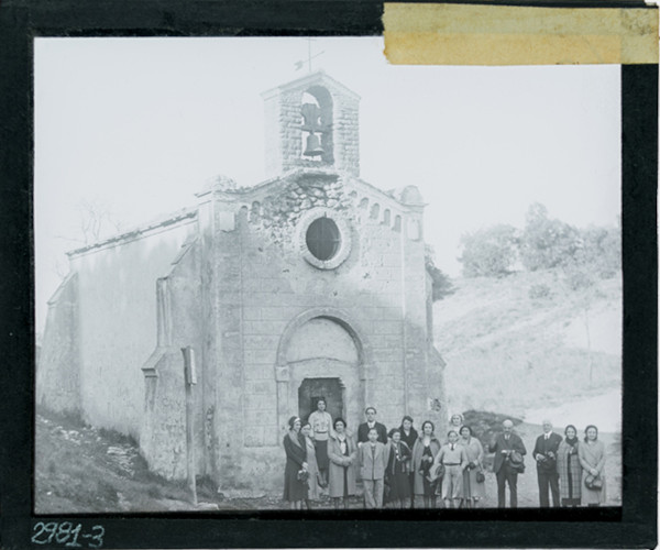 Group of people standing outside small church