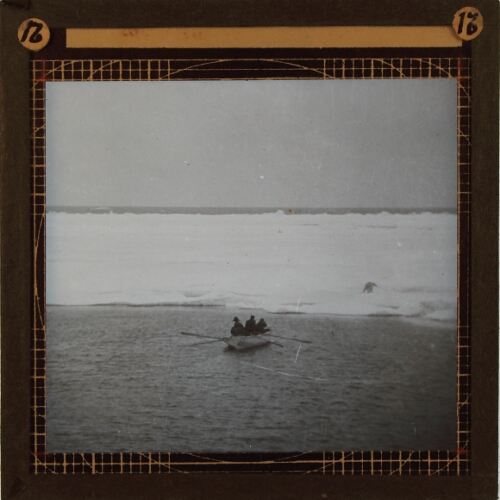 Group of men in rowing boat hunting polar bear