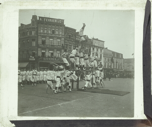 Group of acrobats performing in square in unidentified town or city