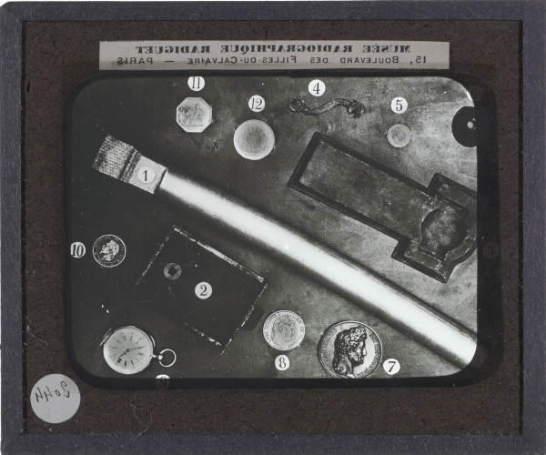 Coins, lock, pocket watch and other objects – secondary view of slide