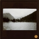 [Lake and wooded hillside in mountainous landscape]