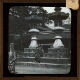 [Two girls standing by lanterns in front of temple]