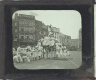 [Group of acrobats performing in square in unidentified town or city]
