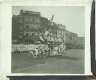 [Group of acrobats performing in square in unidentified town or city]