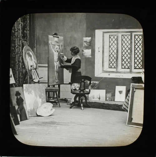 An artist was standing before an easel in a quaint old studio