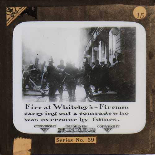 Fire at Whiteley's -- Firemen carrying out a comrade who was overcome by fumes