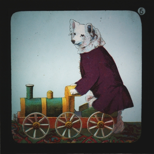 Slide showing dog riding on toy locomotive