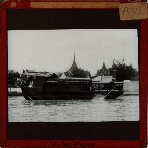 Boat on river with temple spires in background