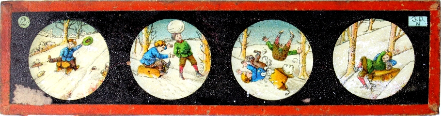 Two children toboganning in snow