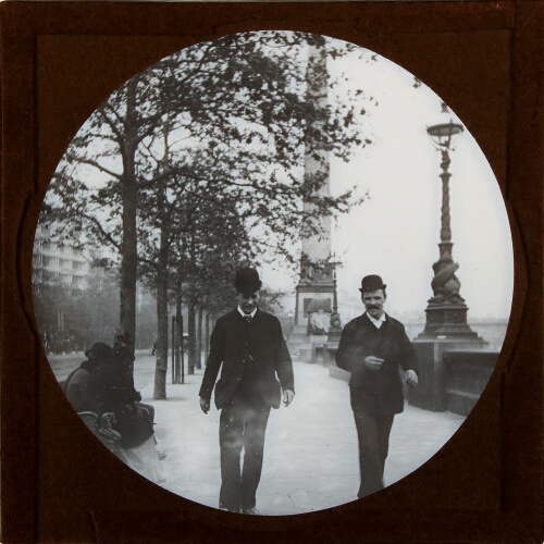 Two men walking along Victoria Embankment, London