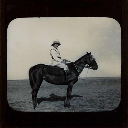 Man wearing uniform sitting on horse