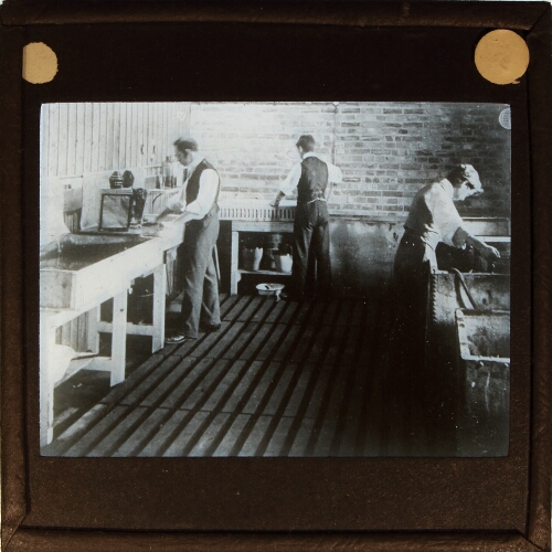 Men working in film developing room