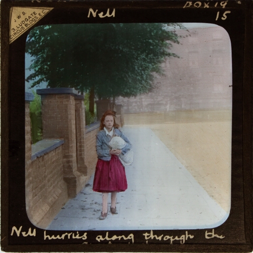 Nell hurries along through the quiet street