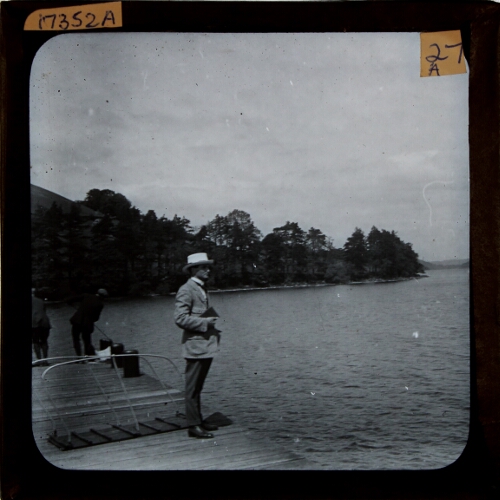Man standing on landing stage by lake
