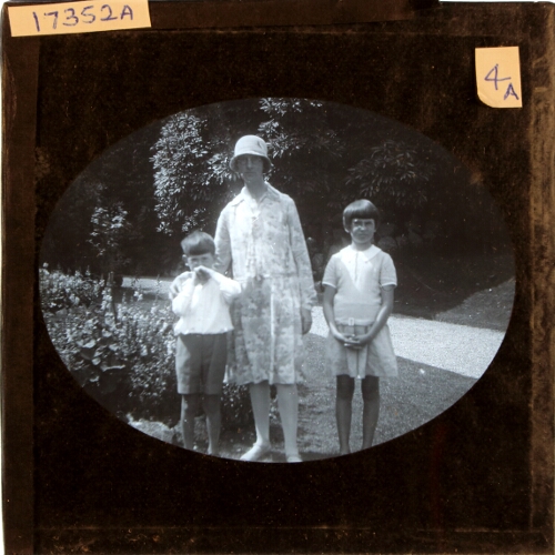 Woman, boy and girl standing in garden