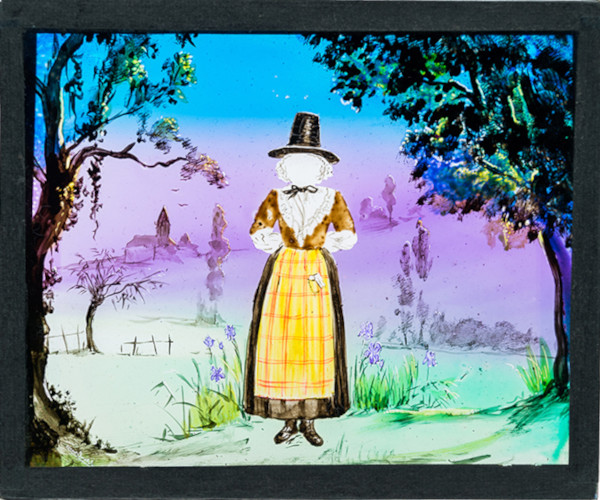 Female figure in Welsh folk costume and rural background