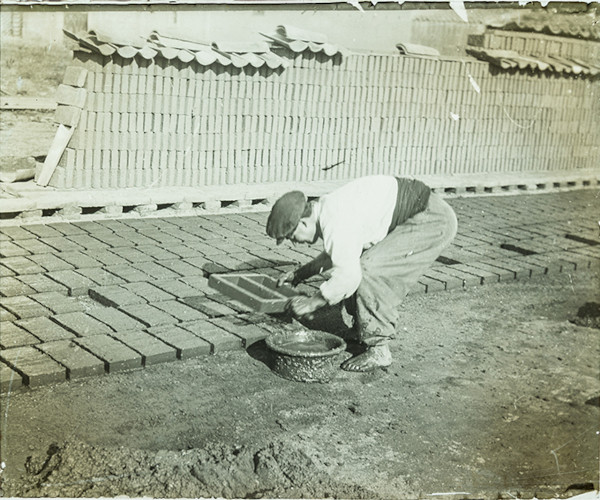 Worker making bricks
