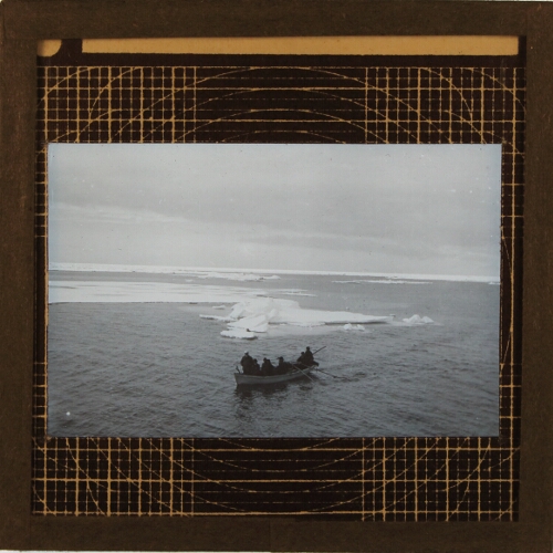 Group of men in rowing boat among ice floes