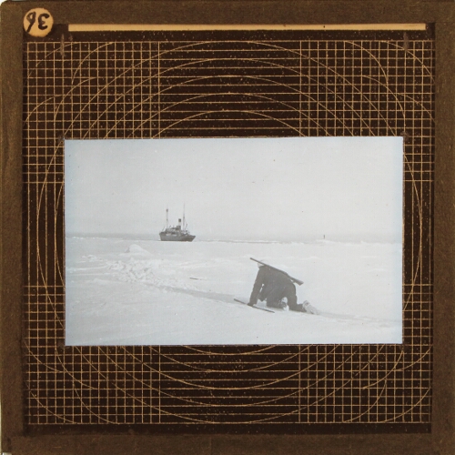 Man with rifles crawling on ice, steamship in background