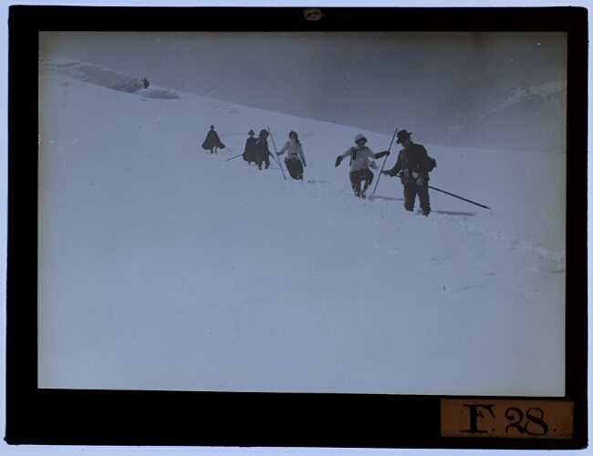 The excursion group descending a mountain covered in snow