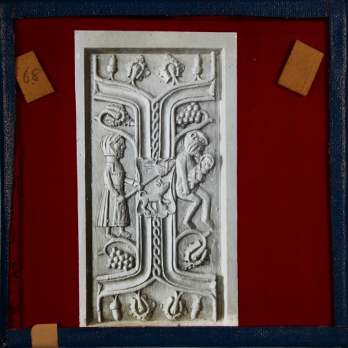 Carving showing woman and man holding baby
