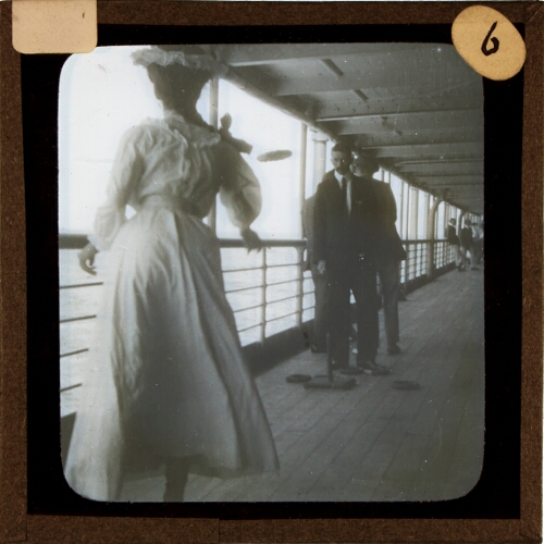 Woman playing deck quoits game on ship