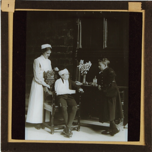 Nurse with two schoolboys, one with injured arm and head