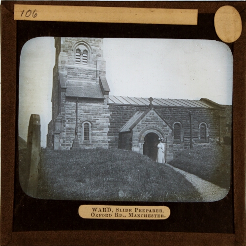 Woman standing at entrance to unidentified church