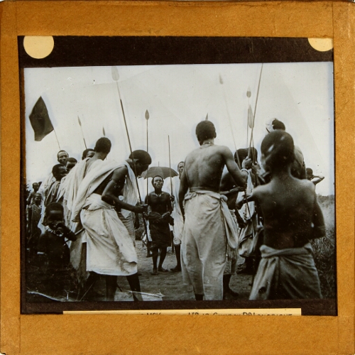 Group of African men dancing with spears