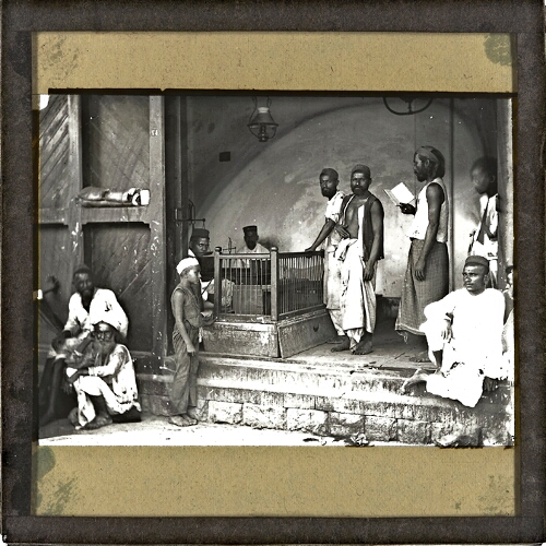 Group of men standing and sitting in workshop