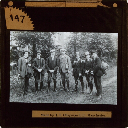 Group of men with rucksacks and walking sticks