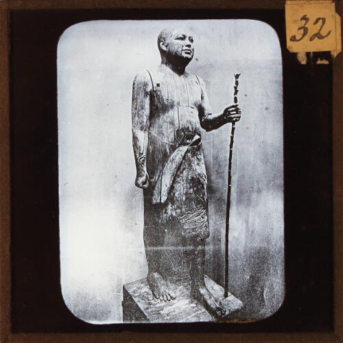 Statue of man holding staff