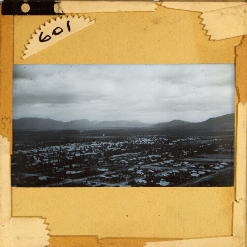 View across unidentified town towards mountains