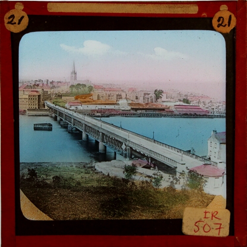 Bridge across river in unidentified town or city