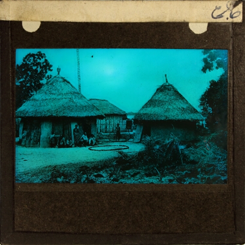 Village of thatched houses with people sitting outside