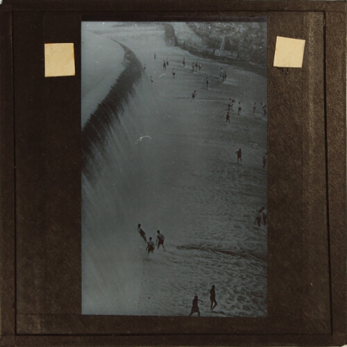 Group of people bathing in waterfall or spillway of large dam
