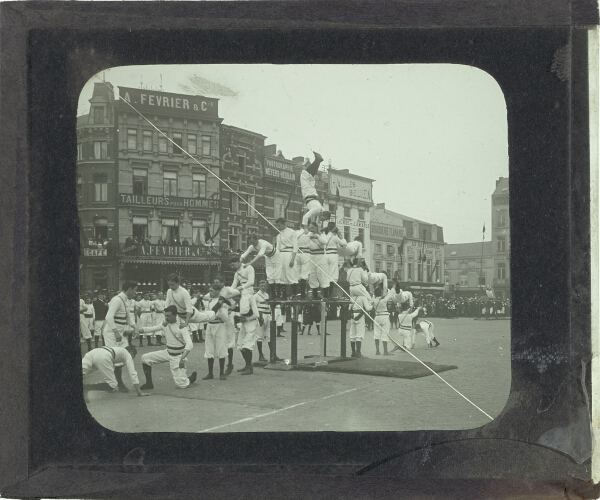 Group of acrobats performing in square in unidentified town or city
