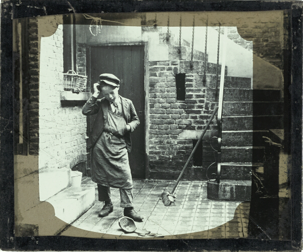 Boy looking at broken pot on floor of basement room – secondary view of slide