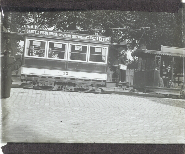 Electric tram with trailer car in unidentified French-speaking city