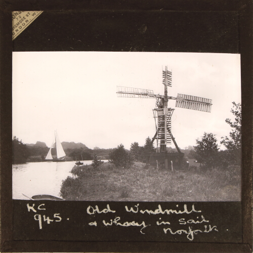 Norfolk Broads. Old Windmill, and Wherry in full sail
