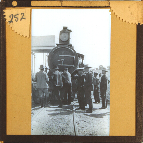 Group of people standing in front of railway locomotive