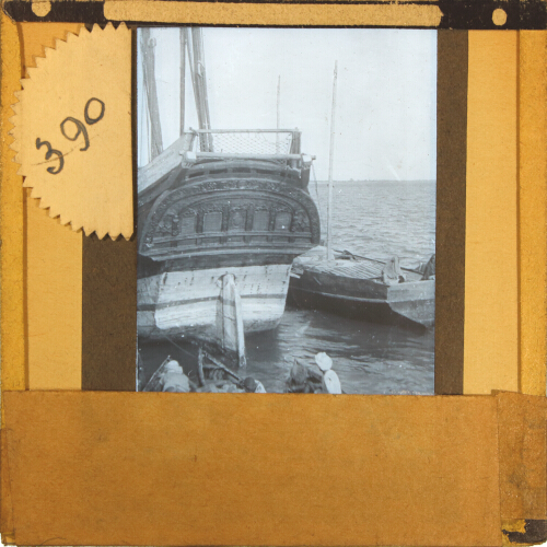 Decorated stern of sailing ship in unidentified port or harbour