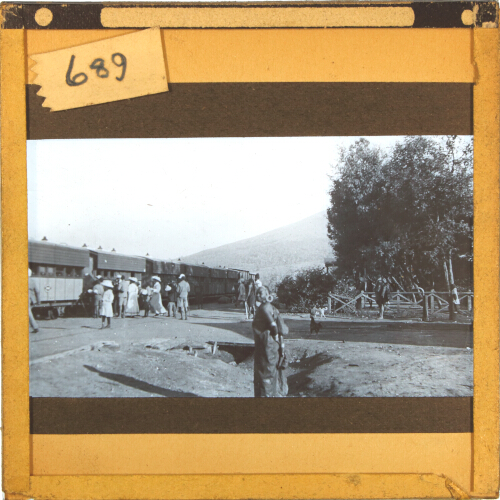 Group of people boarding railway train in rural location